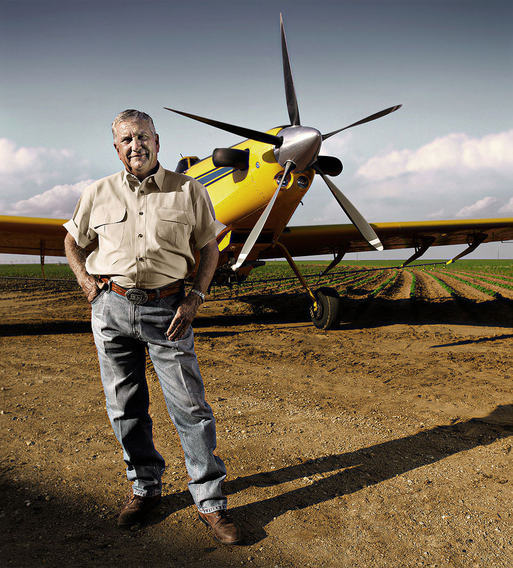 Crop duster pilot Benny White standing in front of his airplane.